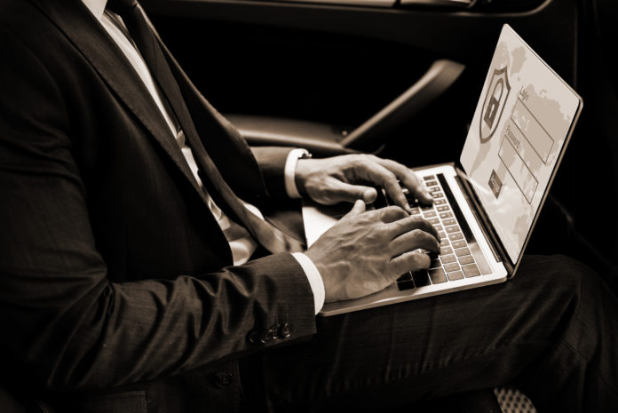 partial view of african american businessman using laptop with i